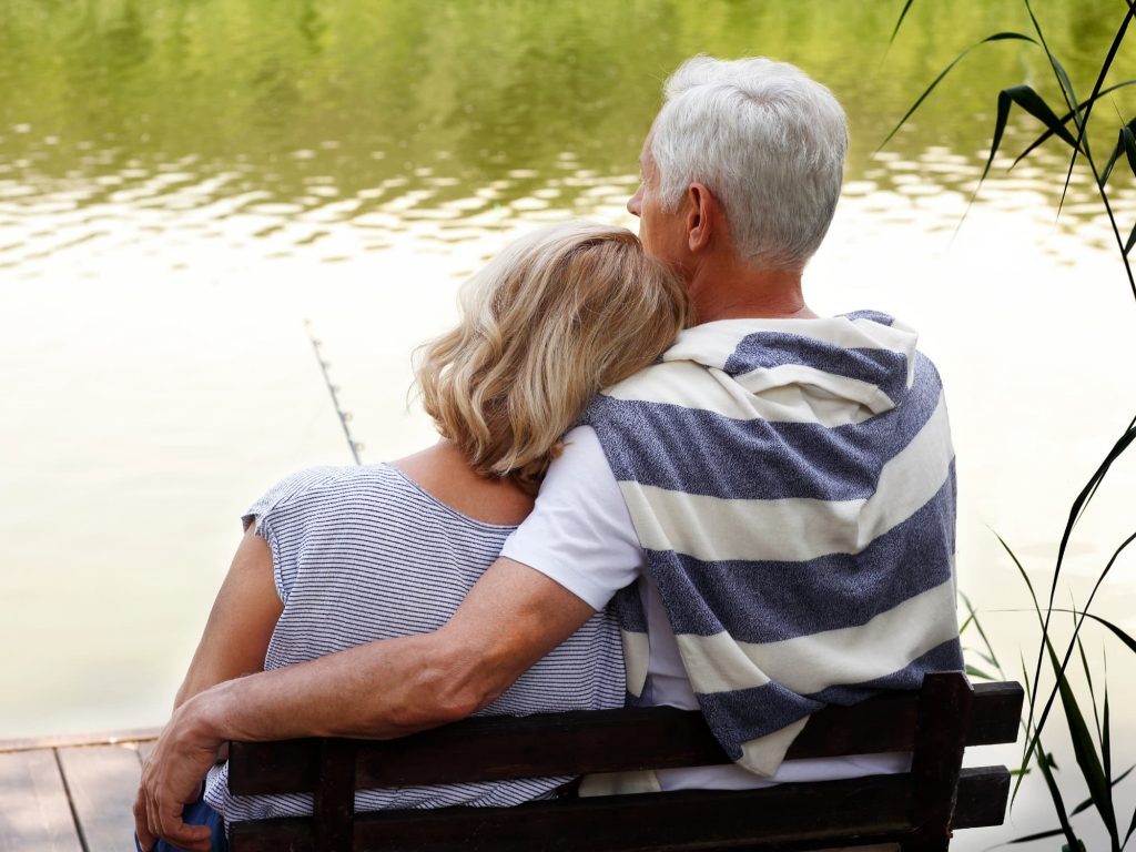 Senior couple sitting at a lake