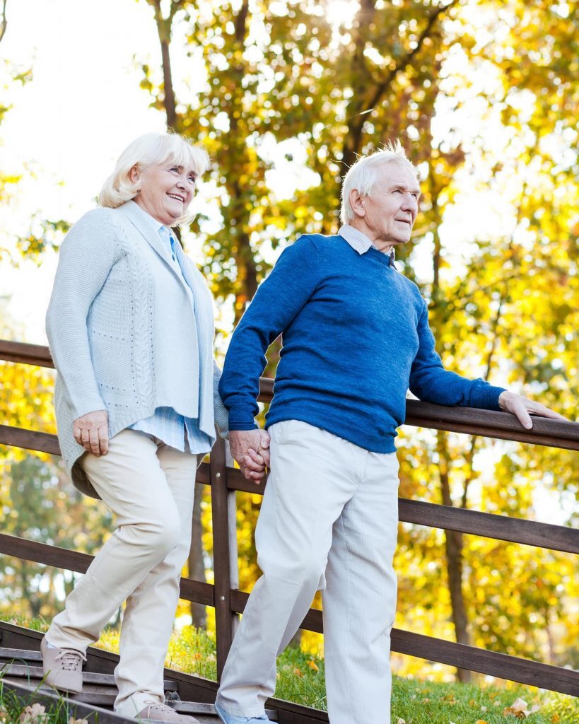 Older couple holding hands and talking